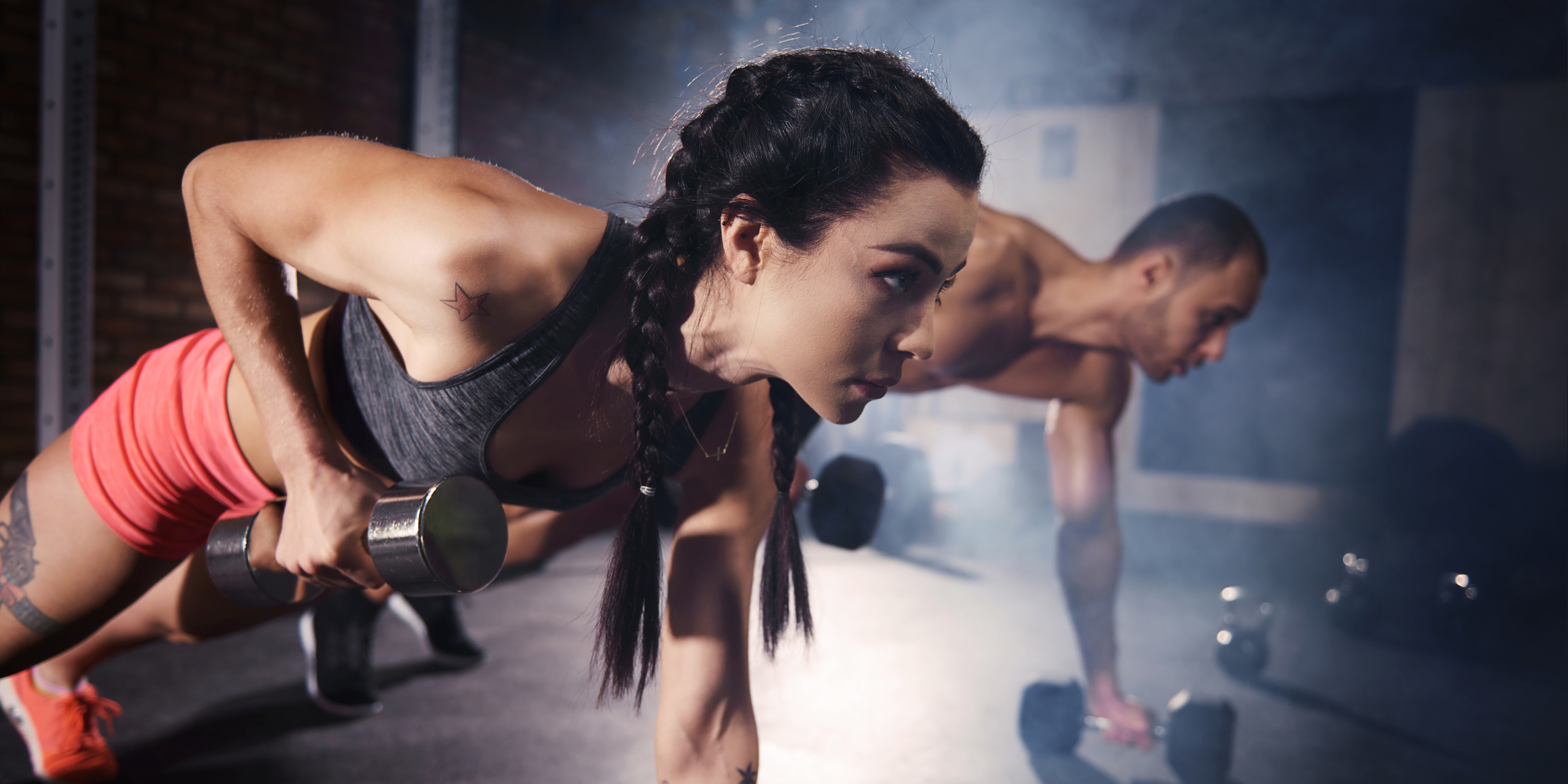 Woman exercising with a dumbbell in a gym setting