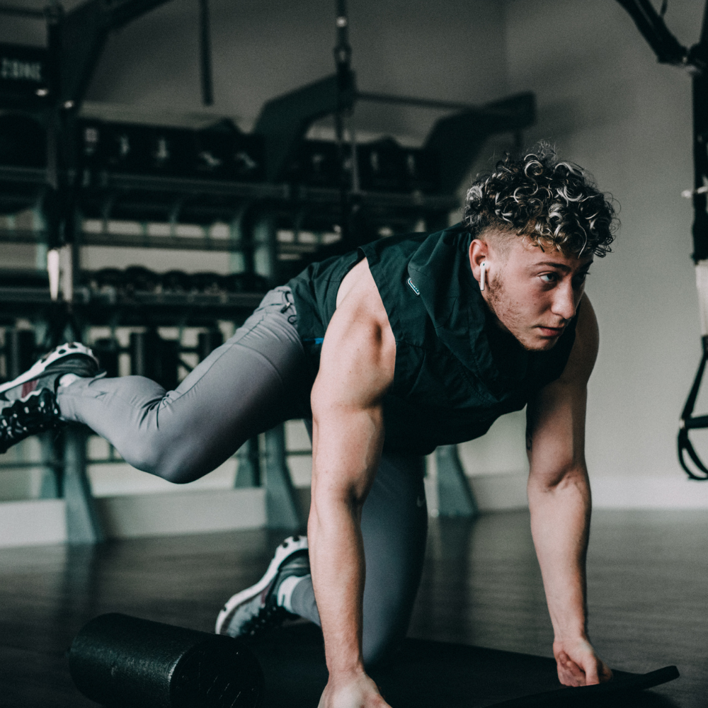 Man performing a push-up in a gym setting